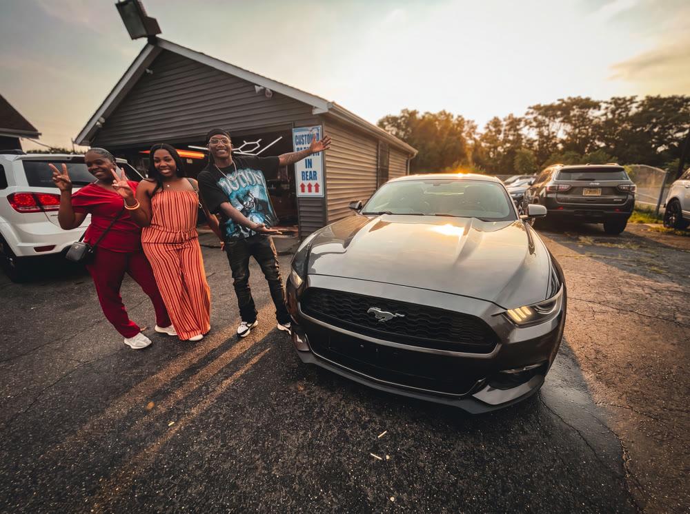Family celebrating their Ford Mustang